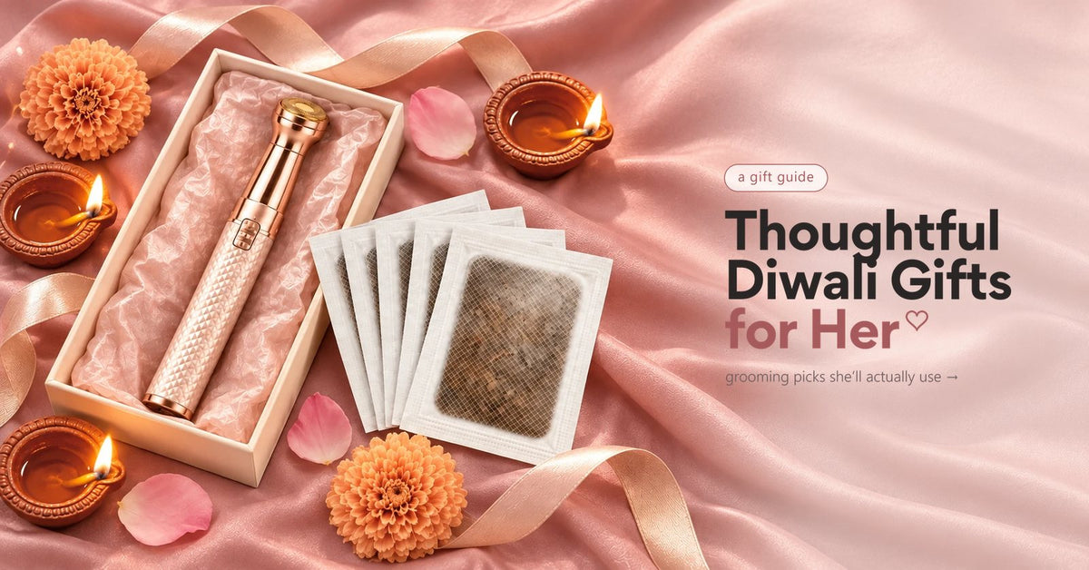 A gold VIFERA 2-in-1 trimmer and herbal foot patches in a gift box on pink satin, with diyas and marigolds