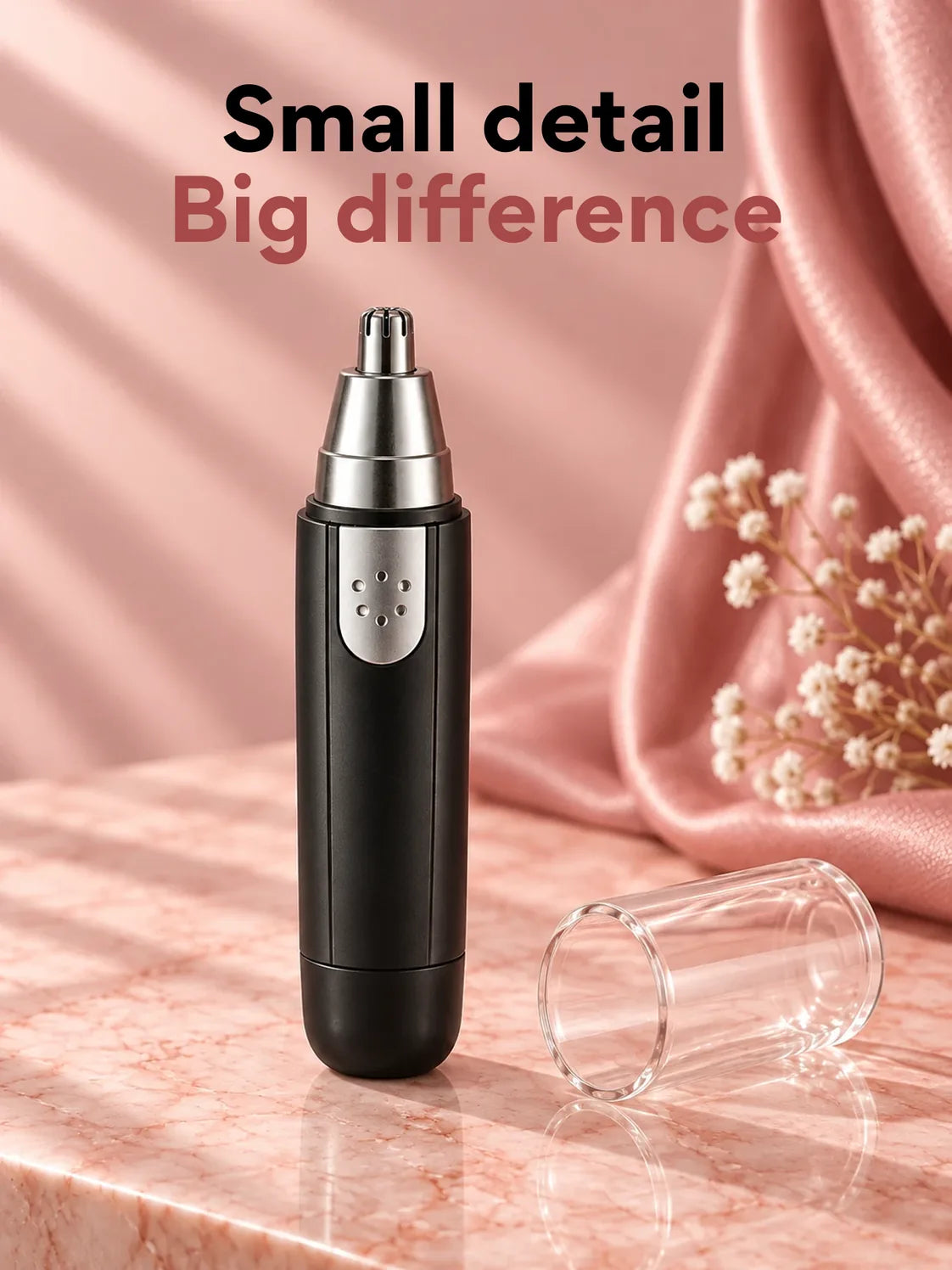 The black 3-in-1 trimmer standing on pink marble, its clear cap beside it