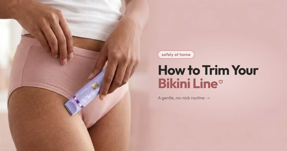 A woman holding a bikini trimmer, for trimming the bikini line safely at home